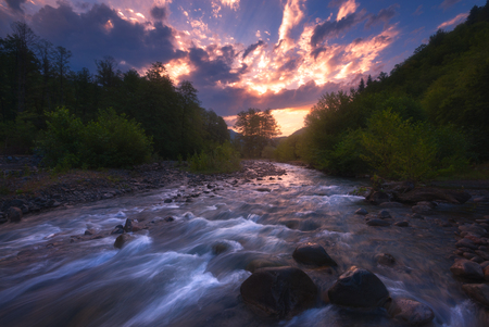 sunrise over fast mountain riverの写真素材