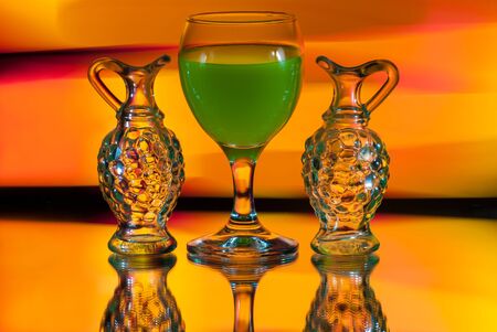 Three glasses on a yellow background. Beautiful still life with green juice