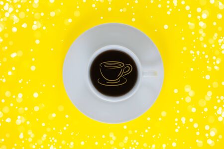 Coffee mug on yellow background, flat lay, top viewの写真素材