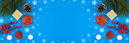 Christmas blue background. Gift or present box and holiday decoration top view. pine cone and...