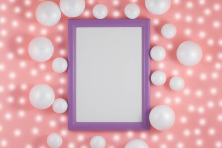 Christmas balls and picture frame on fashion background. Party mockup or invitation. Flat lay