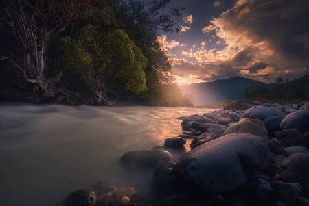 Caucasus. beautiful sunset over fast flowing mountain riverの写真素材