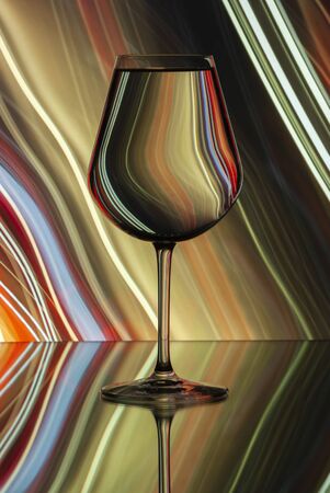 Pattern distortions seen through a glass of water. Still life