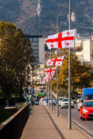 Georgia, Tbilisi - November 17, 2020: Georgian flags on the bridge.のeditorial素材