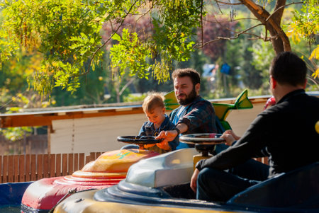 Georgia, Tbilisi - October 25, 2020: Father and son sit in the boat and have fun.のeditorial素材