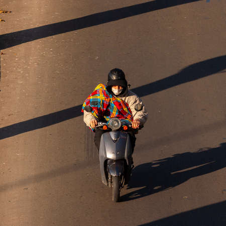 Georgia, Tbilisi - November 28, 2020: Man riding motorcycle on city road.のeditorial素材
