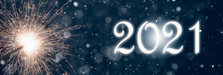 Abstract Defocused Celebration New Years 2021 - Burning sparkler on abstract snowy background. 3d...