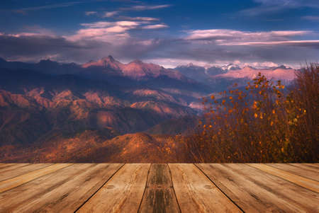 Autumn beautiful background. Mountains and empty wooden table in nature outdoor. Natural template landscape.の写真素材