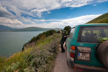 Georgia, Javakheti - July 25, 2015: The traveling man enjoys a magnificent view of the Lake.のeditorial素材
