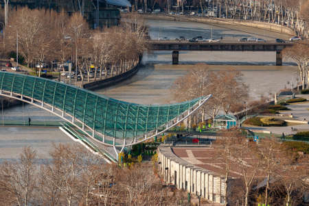 Georgia, Tbilisi - March 19, 2021: Bridge of Peace over the Kura River in Tbilisi, Georgia.