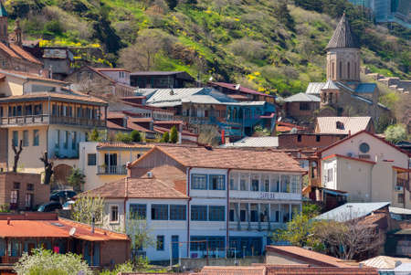 Georgia, Tbilisi - April 15, 2021: Houses with balconies in the historic district of Tbilisi. Georgia. Evening View. Beautiful Old town at sunset.のeditorial素材