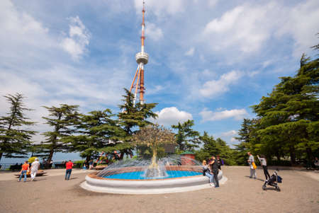 Georgia, Tbilisi - May 8, 2021: People walk in the city park.のeditorial素材