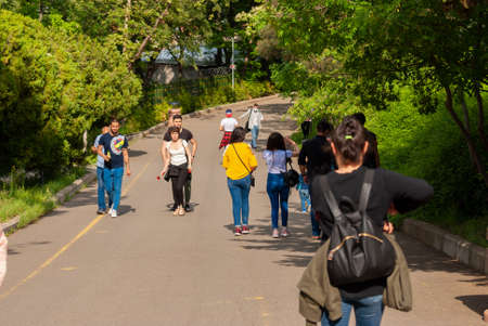 Georgia, Tbilisi - May 8, 2021: People walk in the city park.のeditorial素材