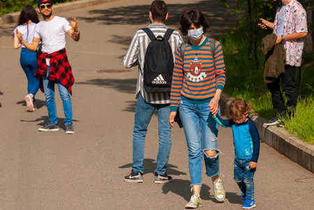 Georgia, Tbilisi - May 8, 2021: People walk in the city park.のeditorial素材