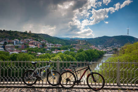Georgia, Tbilisi - May 18, 2021: Bicycles in front of a beautiful view of the city.
