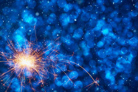 Burning sparkler on abstract snowy background. New Year celebration. 3d illustration.の写真素材