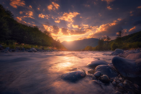 Beautiful sunset over fast flowing mountain river.の写真素材