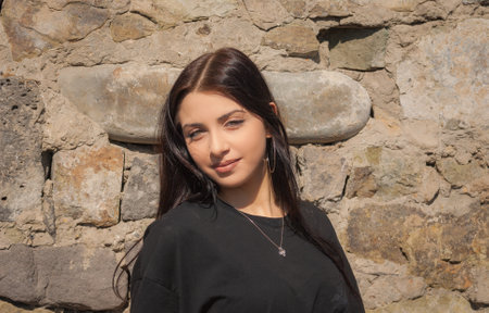 Cute teen girl posing in a city park at spring evening.