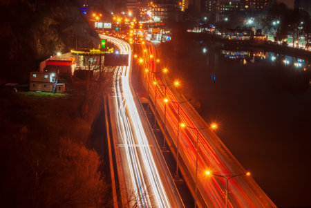 Georgia, Tbilisi - December 30, 2021: Traffic on city street at night.のeditorial素材