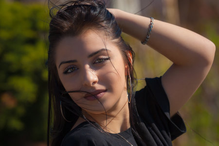 Cute teen girl posing in a city park at spring evening.
