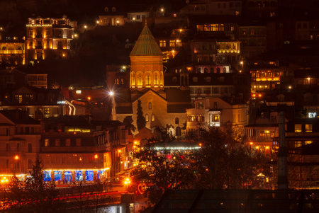 Georgia, Tbilisi - December 30, 2021: Houses with balconies in the historic district of Tbilisi. Beautiful old town at night.の写真素材
