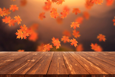 Idyllic blurred autumn landscape with fall leaves and empty wooden table.の写真素材