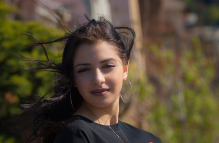 Cute teen girl posing in a city park at spring evening.の写真素材