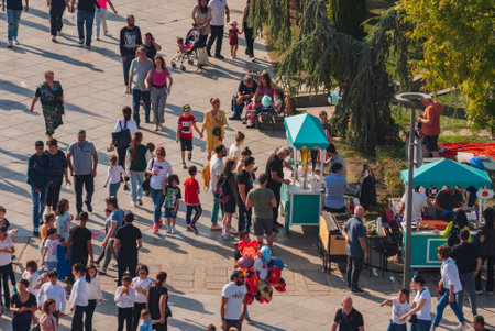 Georgia, Tbilisi - October 2, 2022: Group of anonymous People in City Parkのeditorial素材