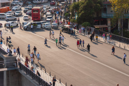 Georgia, Tbilisi - October 2, 2022: Group of anonymous People in City Parkのeditorial素材