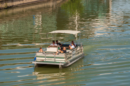 Georgia, Tbilisi - September 17, 2022: Tourists ride on a pleasure boat along the Mtkvari, Kura River.のeditorial素材