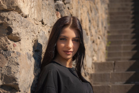 Cute teen girl posing in a city park at spring evening.の写真素材