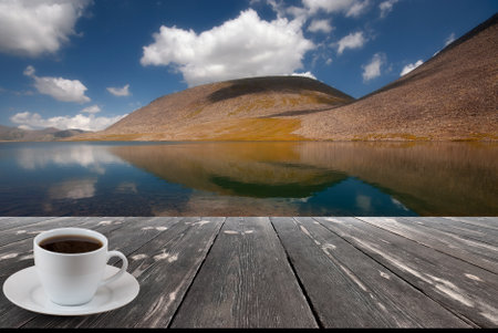 Coffee cup on wood table and view of beautiful nature background.の写真素材