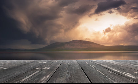 Dark storm clouds over lake, with empty wooden table. natural template landscape