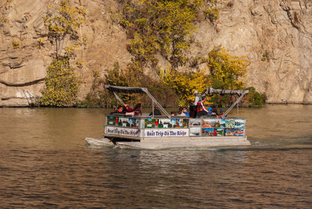 Georgia, Tbilisi - October 30, 2022: Tourists ride on a pleasure boat along the Mtkvari, Kura River.のeditorial素材