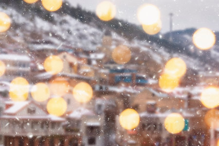 Beautiful winter blurred background of Tbilisi city with falling snow and bokeh lights.の写真素材