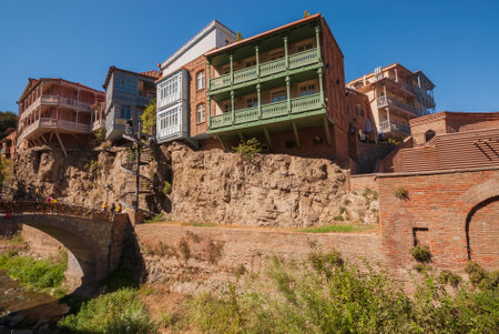 Georgia, Tbilisi - September 25, 2022: Houses with balconies in the historic district of Tbilisi. Georgia. evening view. Beautiful old town at sunset.のeditorial素材