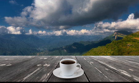 Coffee cup on wood table and view of beautiful nature background.の写真素材