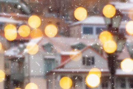 Beautiful winter blurred background of Tbilisi city with falling snow and bokeh lights.の写真素材