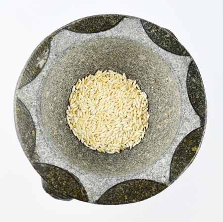 Parched rice in a mortar Isolated on white background の写真素材