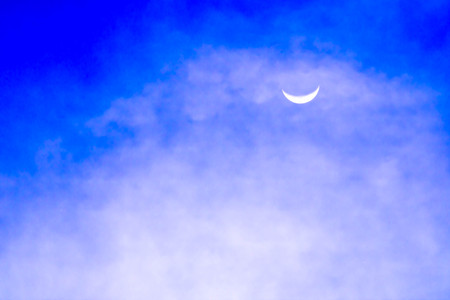 Blue sky with clouds and the moon.