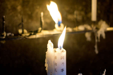 burning Japanese lettered candles