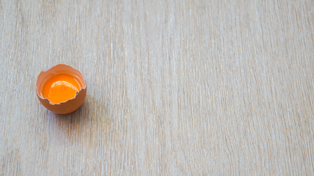 egg yolk in shell on a wooden backgroundの写真素材