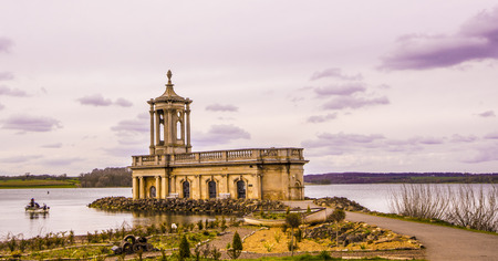 chapel on the water and anglers on the boatの写真素材