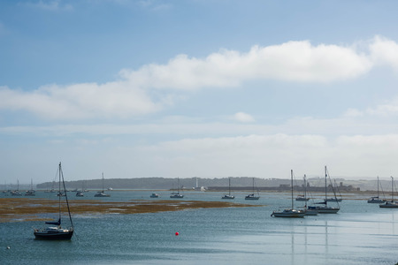 moored boats on a stormy afternoon Hurst Spit near Keyhaven New Forest Hampshire England UKの写真素材