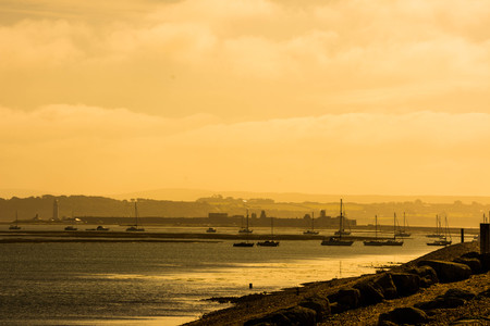 moored boats on a stormy afternoon Hurst Spit near Keyhaven New Forest Hampshire England UKの写真素材