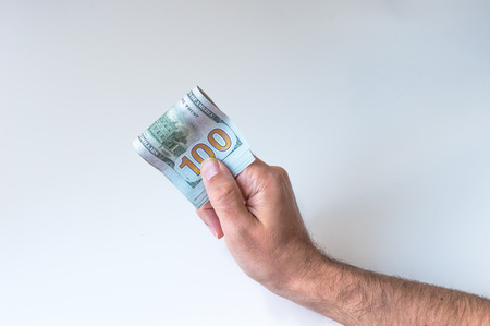 Man holding hundred US Dollarsの写真素材