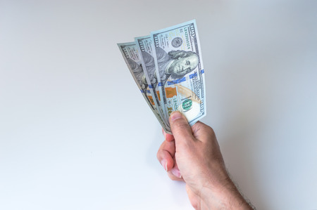 Man giving three hundred US Dollarsの写真素材