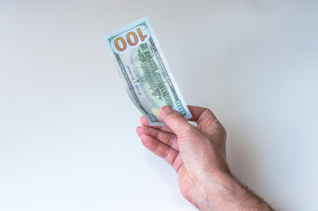 Man giving one hundred US Dollarsの写真素材