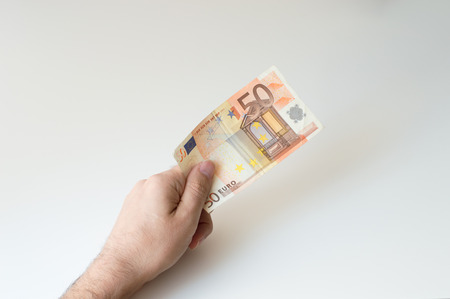 Man holding fifty  Euro banknote in his hands