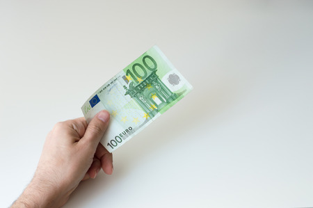 Man holding one hundred Euro banknote in his handsの写真素材